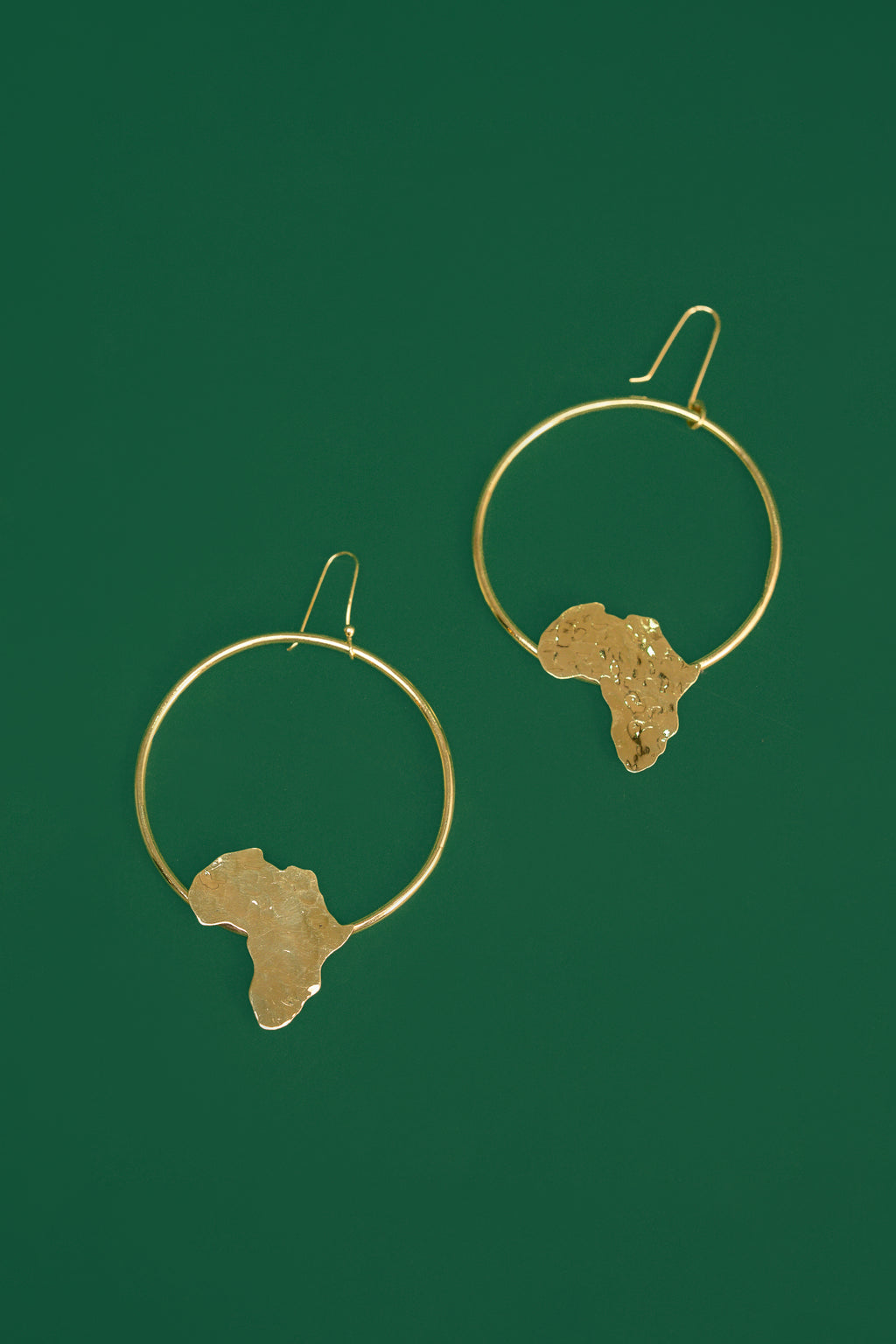 Gold hoop earrings with an  Africa map shape accent on the bottom part of the hoop