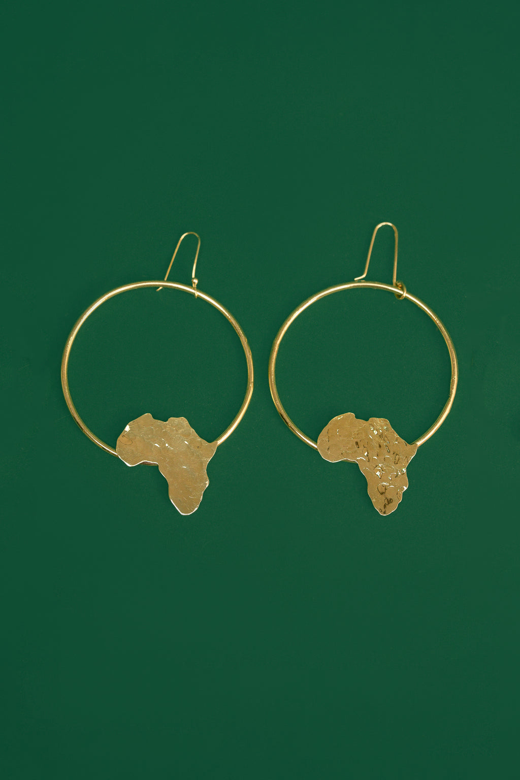 Gold hoop earrings with an  Africa map shape accent on the bottom part of the hoop