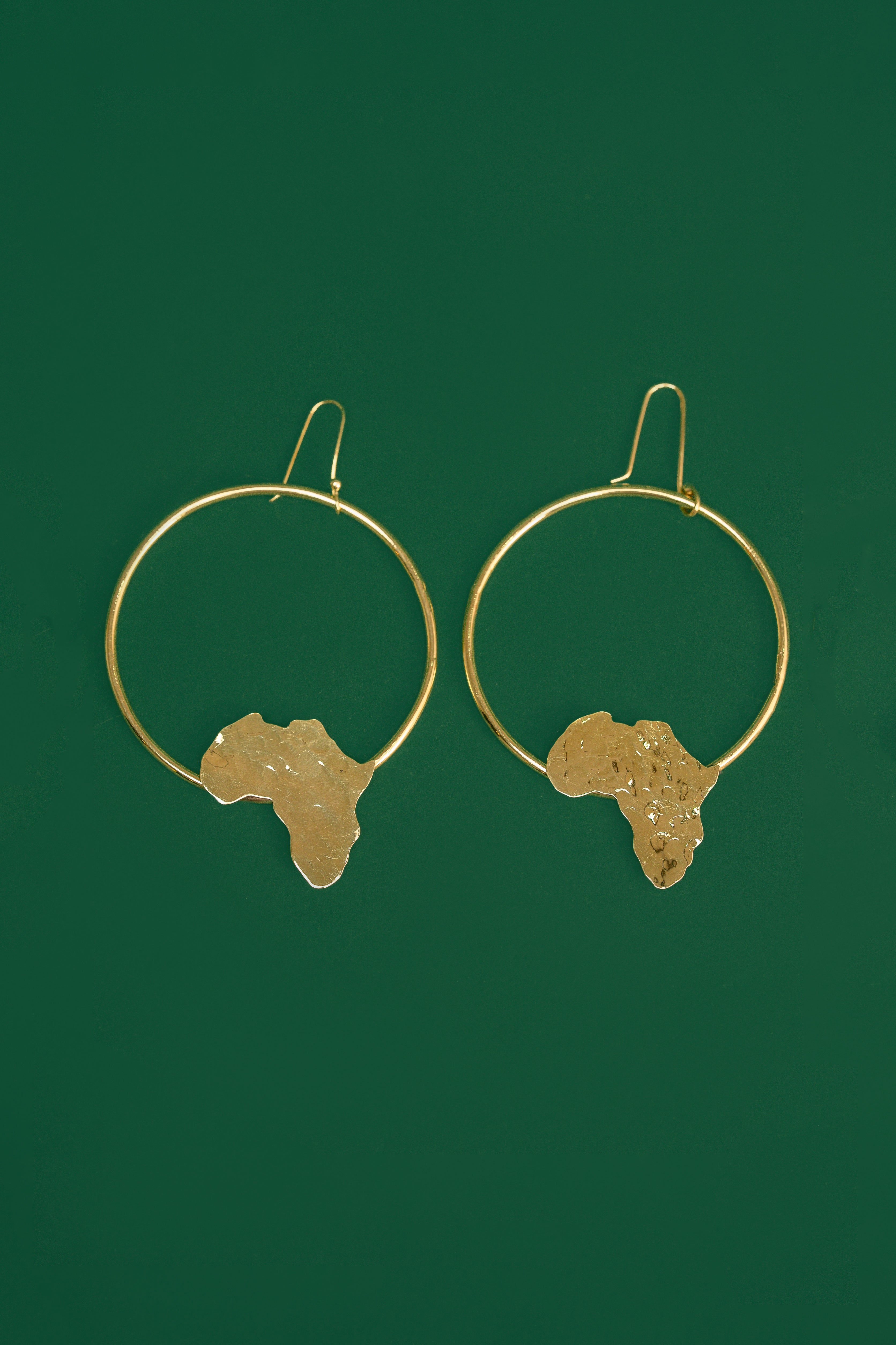 Gold hoop earrings with an  Africa map shape accent on the bottom part of the hoop