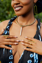 model wearing rectangular bar earrings, a bar pendant choker, and bar shaped rings