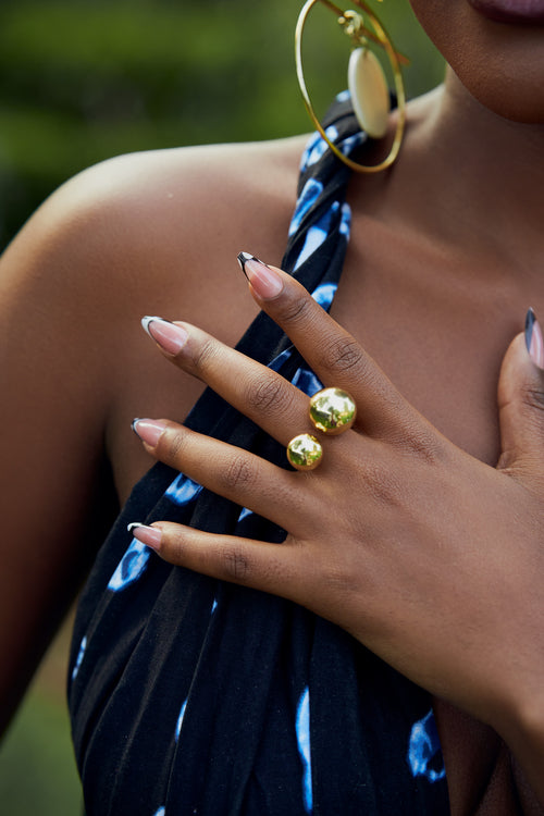 Close-up of a model wearing a gold double orb design ring 
