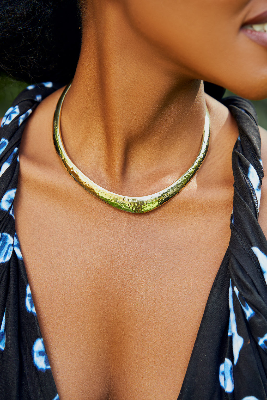 Close-up of a model wearing a gold choker