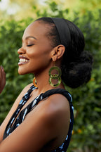 Model wearing gold interlocking double hoop earrings