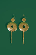 model wearing gold hoop earrings with a bar column pendant 