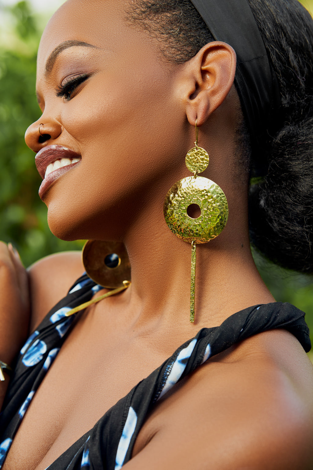 model wearing gold hoop earrings with a bar column pendant 