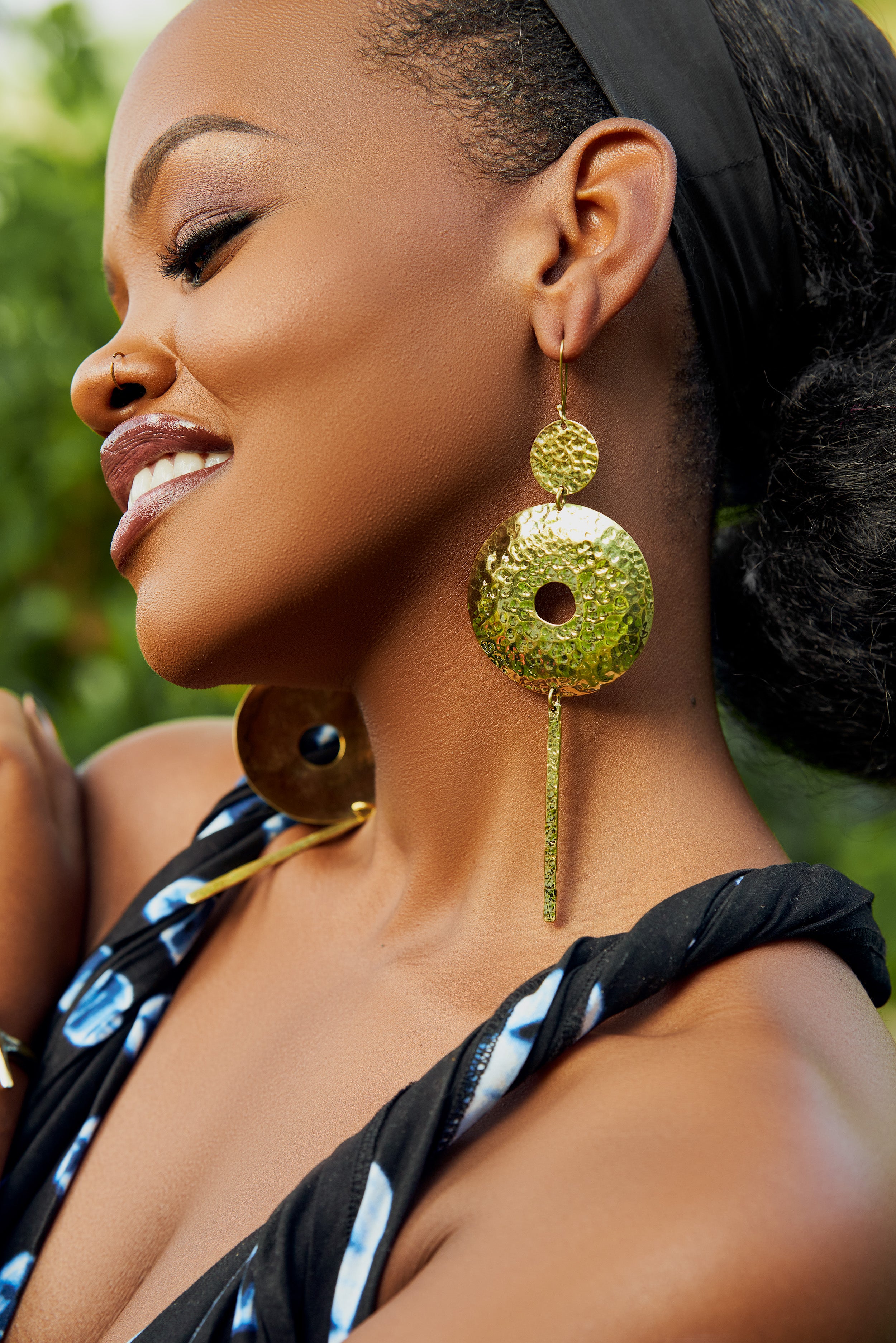 model wearing gold hoop earrings with a bar column pendant 
