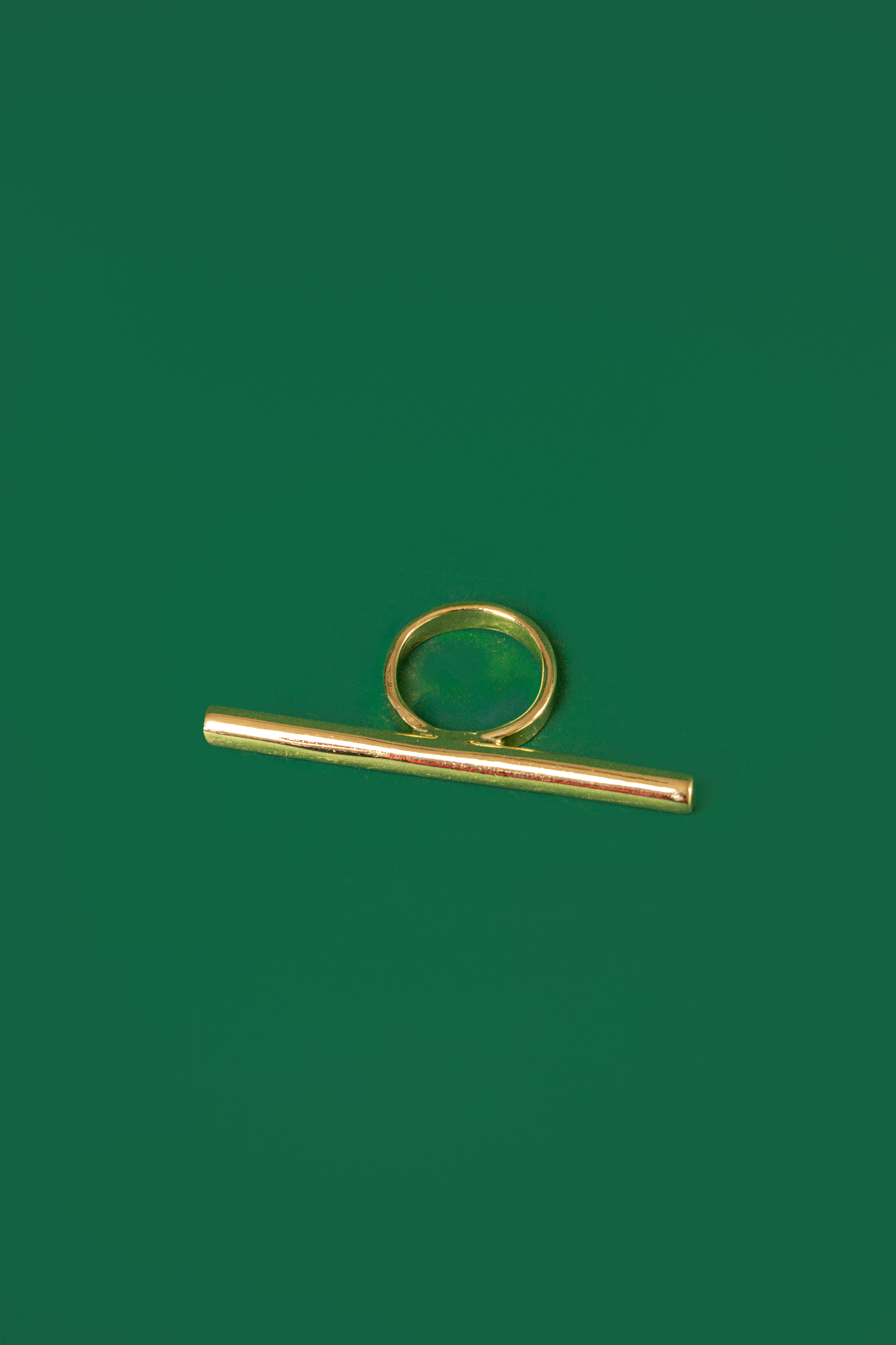 A gold bar horizontal bar ring