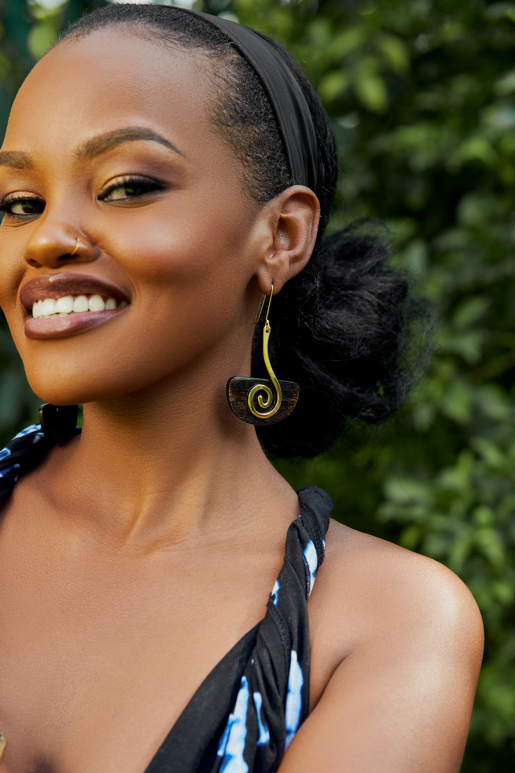 model wearing gold and brown spiral drop earrings 
