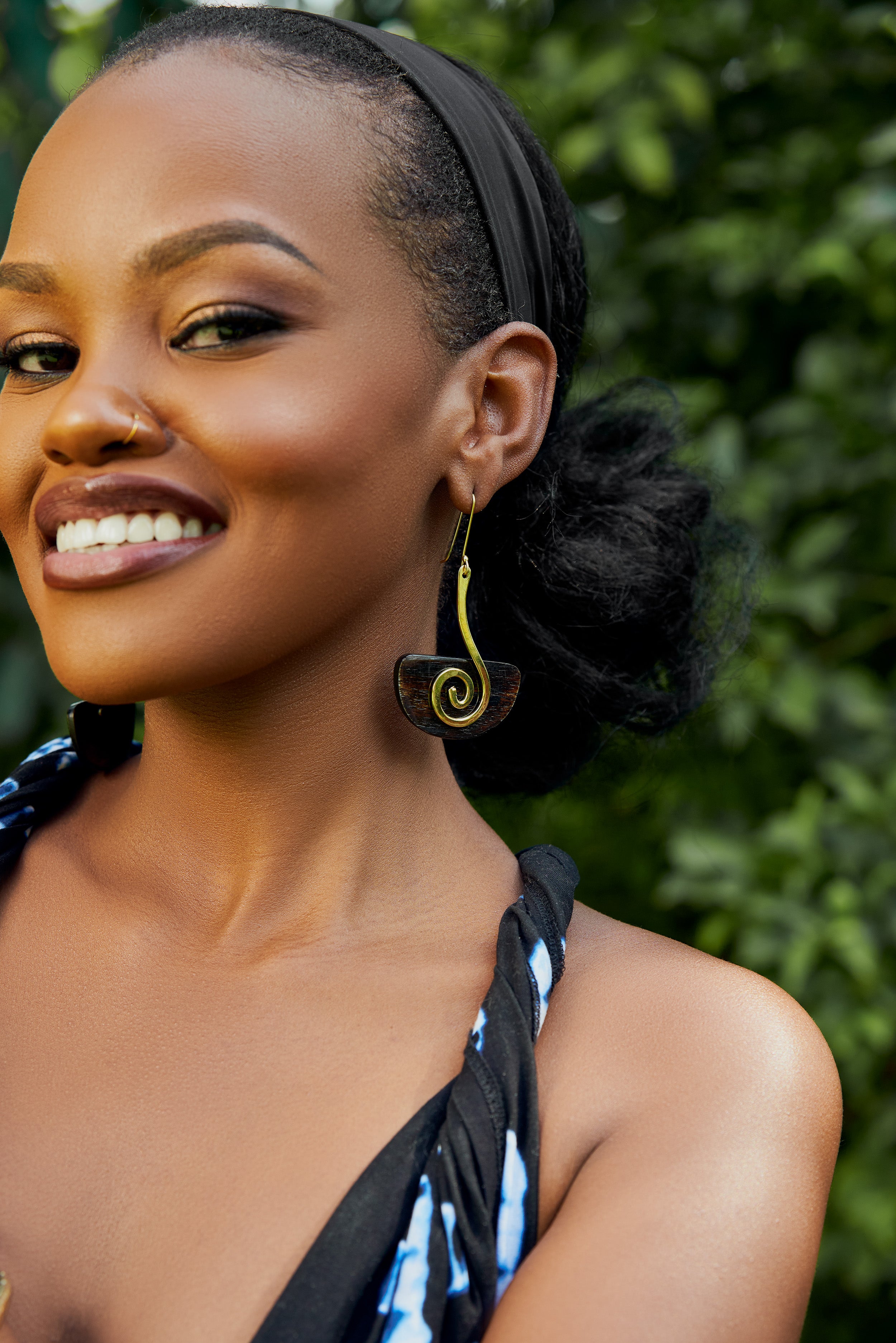 model wearing gold and brown spiral drop earrings 