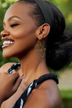 Model wearing a gold Africa map earring