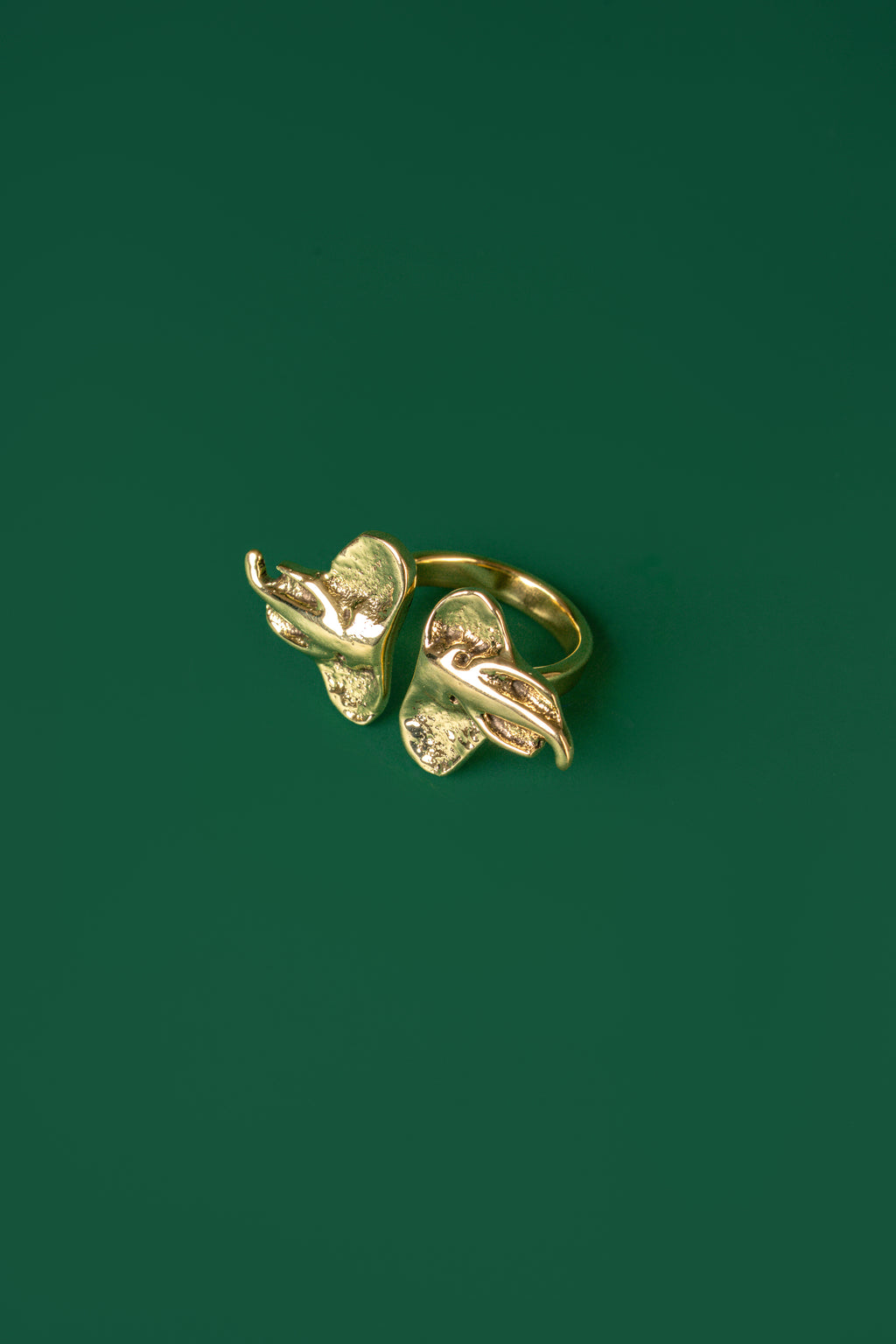 A gold ring with two elephant head ends 
