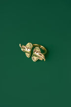 A gold ring with two elephant head ends 