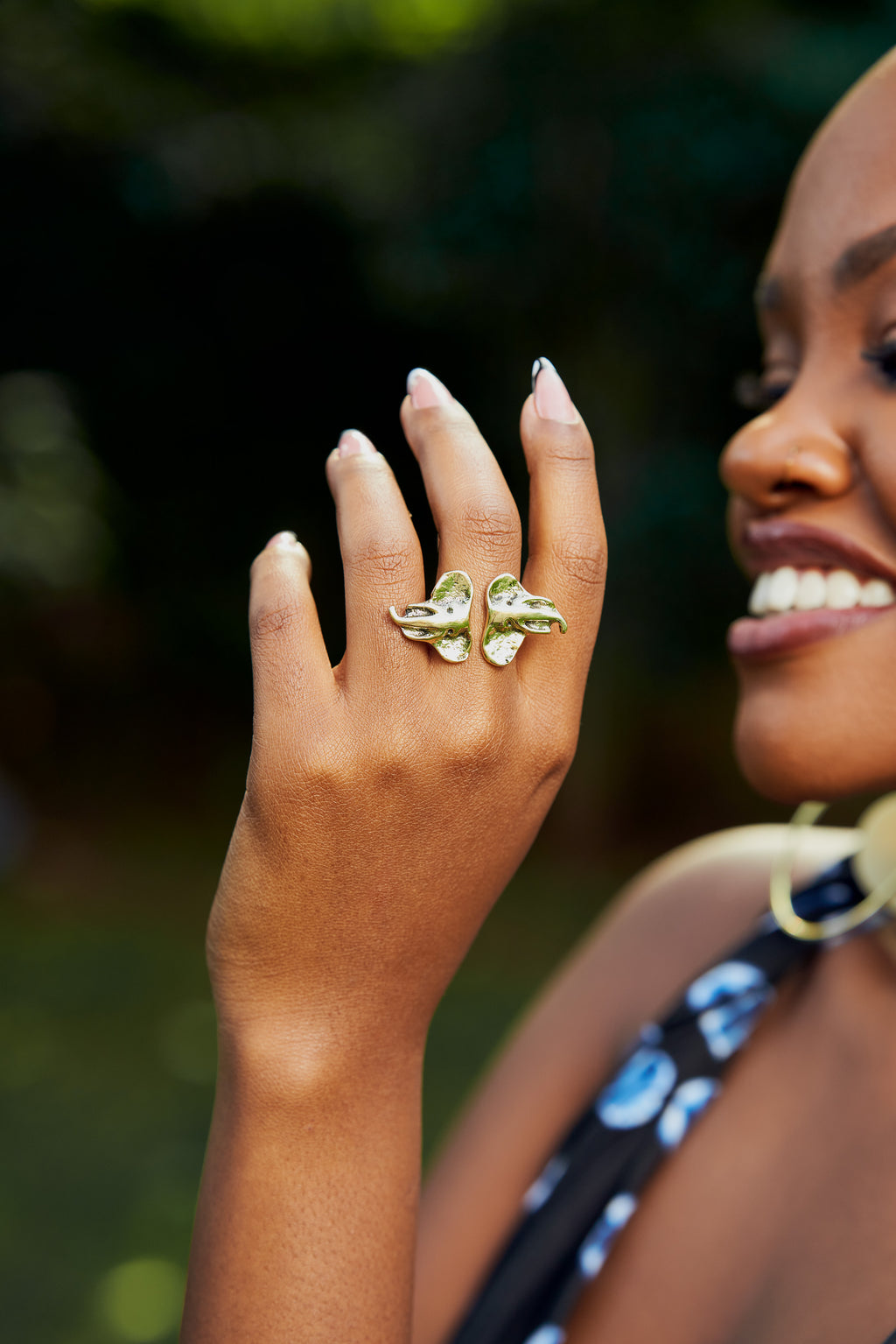 model wearing a ring with two elephant head ends 
