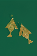A pair of gold geometric dangle earrings with textured, hammered surfaces, displayed against a solid dark green background.