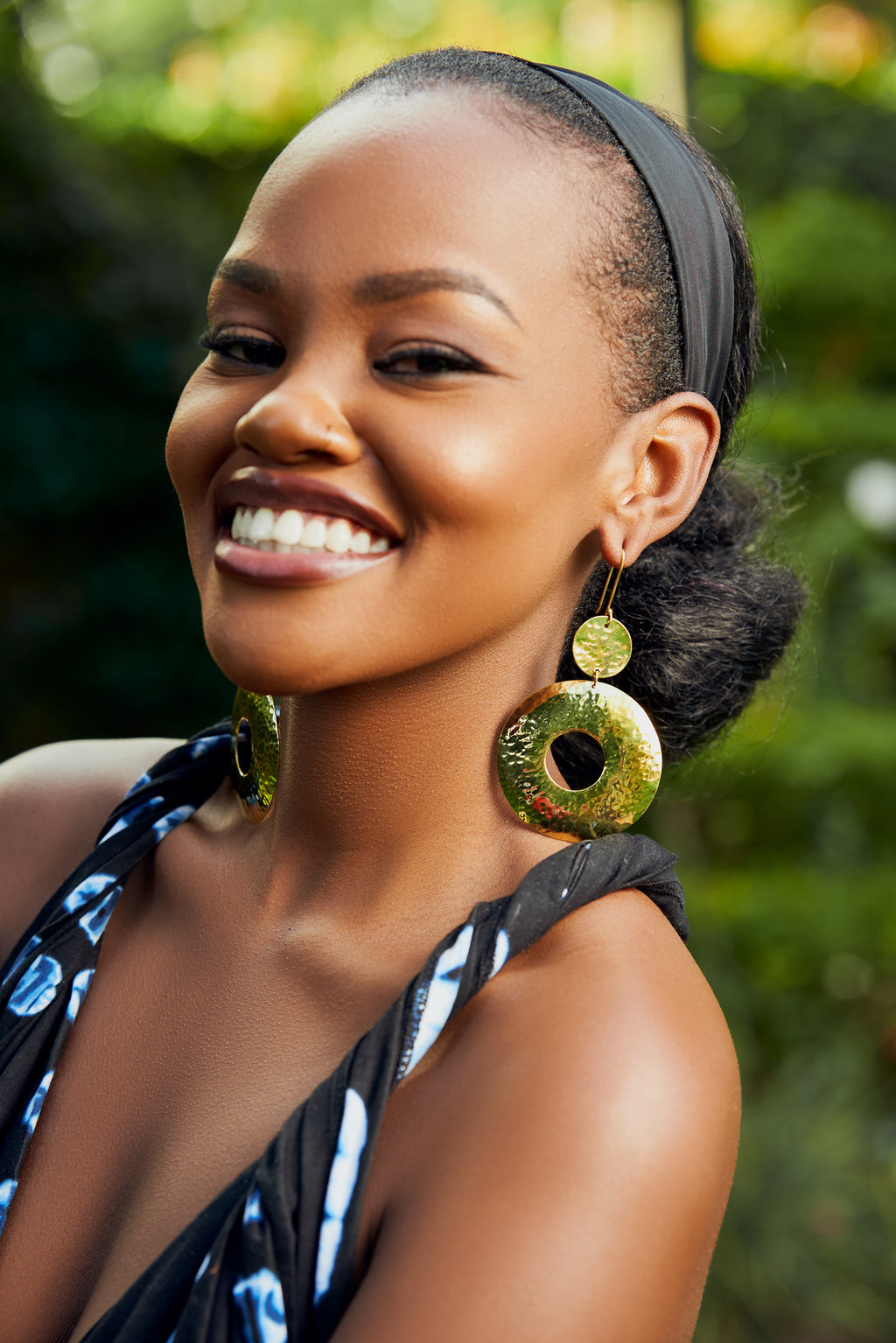 model wearing gold dangle hoop earrings