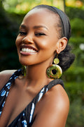 model wearing gold dangle hoop earrings