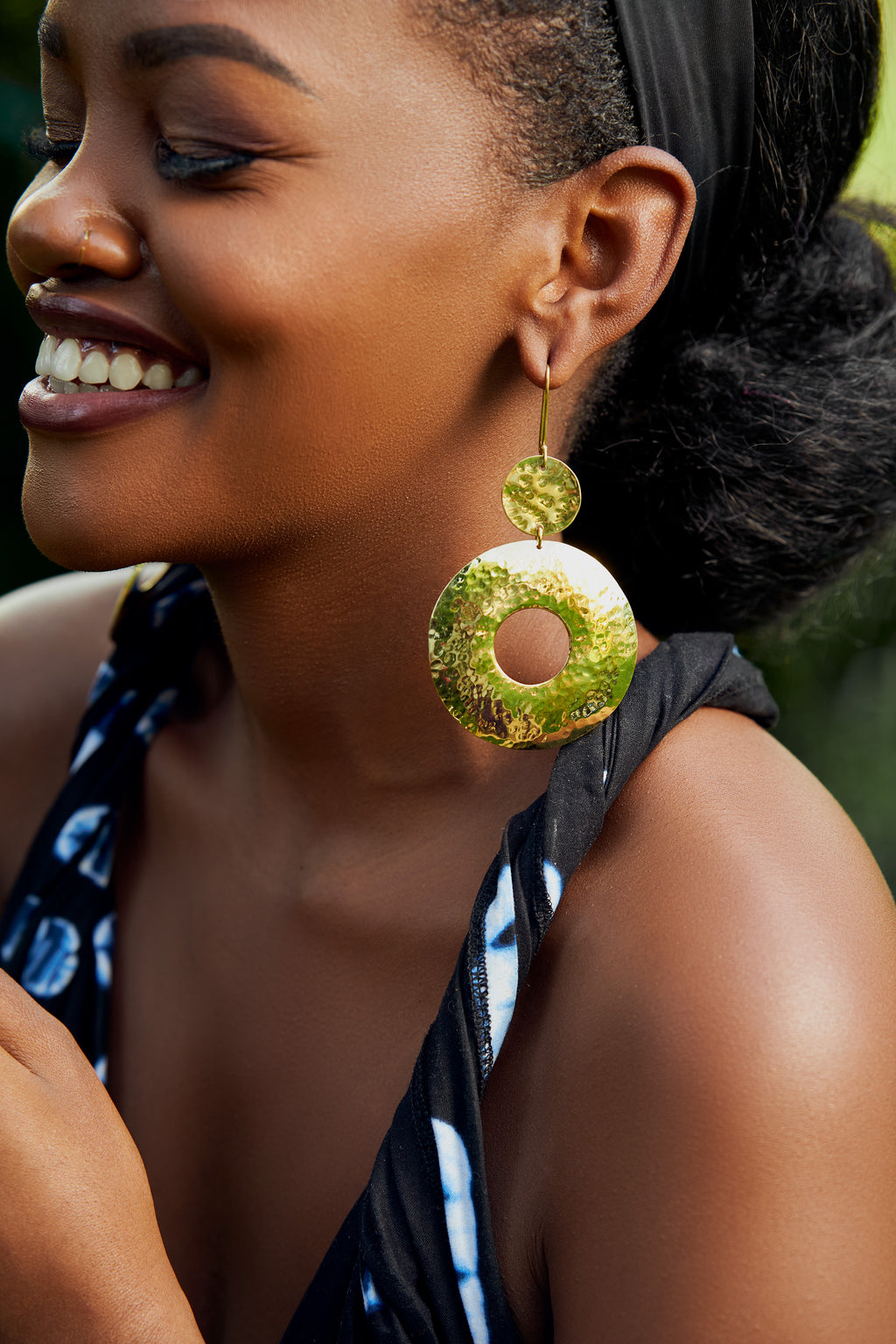 model wearing gold dangle hoop earrings